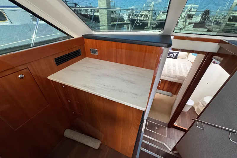 Slide: The Image of Interior of 2016 Riviera 43 Open Flybridge yacht with wood cabinetry and cozy bedroom. - 12
