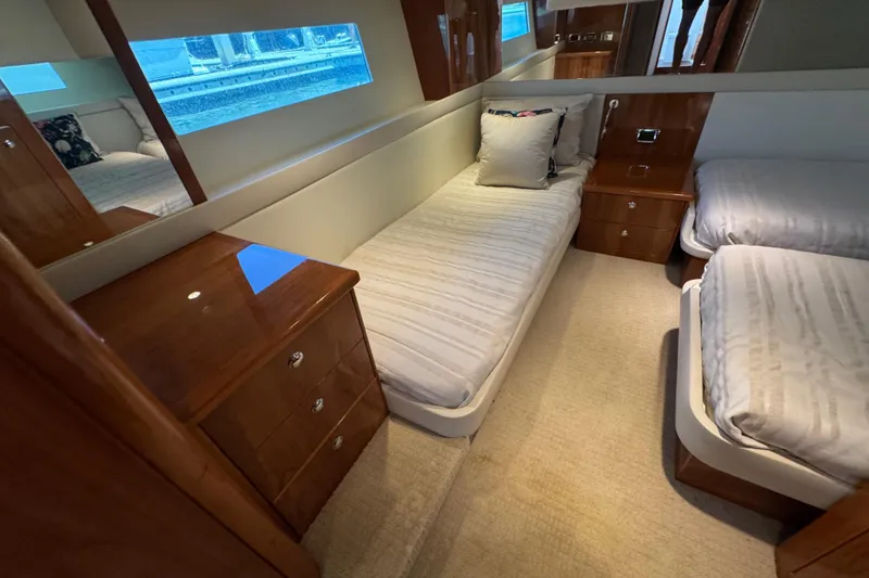 Slide: The Image of Luxurious 2016 Riviera 43 Open Flybridge cabin with twin beds and elegant wood furnishings. - 19