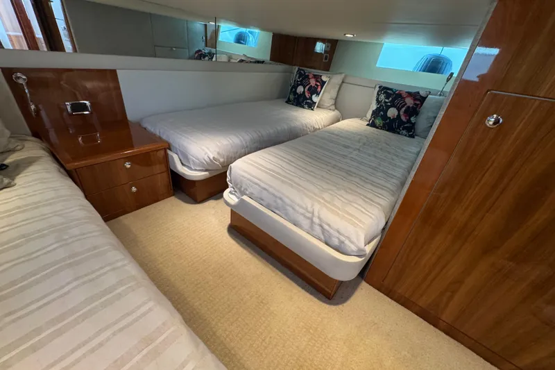 Slide: The Image of 2016 Riviera 43 Open Flybridge cabin with twin beds and wooden furnishings. - 20
