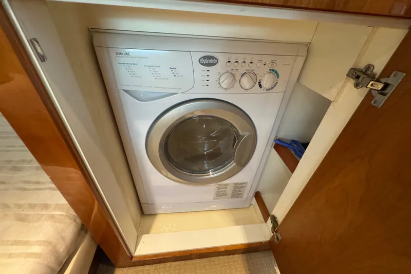 Slide: The Image of Washing machine inside 2016 Riviera 43 Open Flybridge yacht's wooden cabinet. - 21