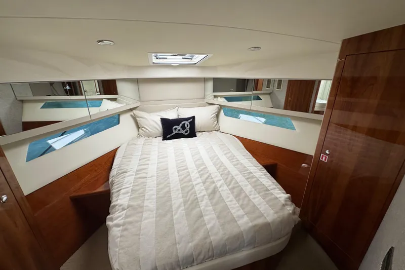Slide: The Image of Luxurious bedroom interior of 2016 Riviera 43 Open Flybridge yacht with elegant wood finishes. - 22