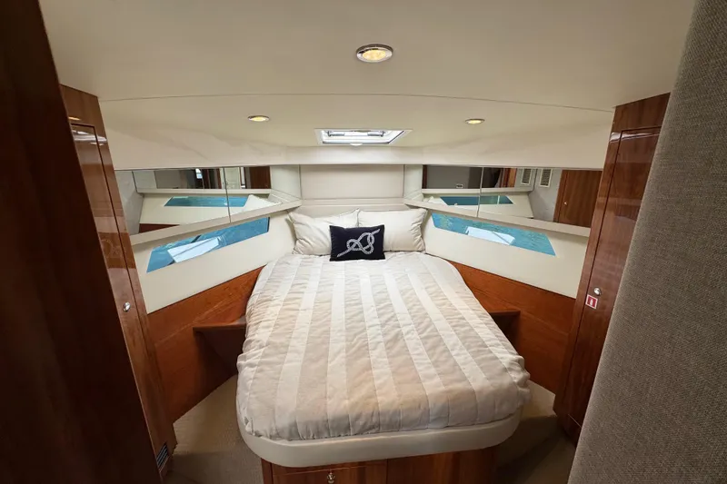 Slide: The Image of Luxurious bedroom interior of 2016 Riviera 43 Open Flybridge yacht with elegant wood finish. - 23