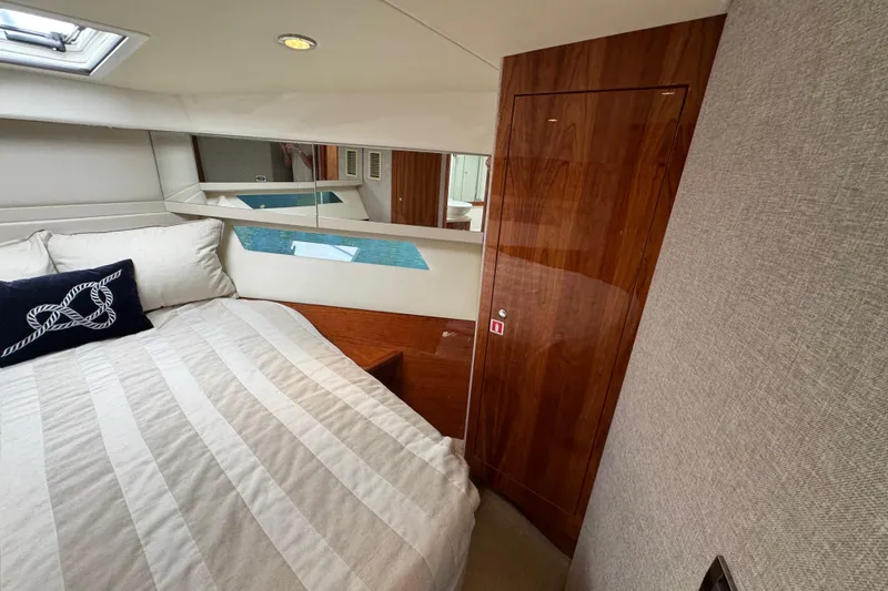 Slide: The Image of Luxurious bedroom interior of 2016 Riviera 43 Open Flybridge yacht with elegant wood finish. - 24