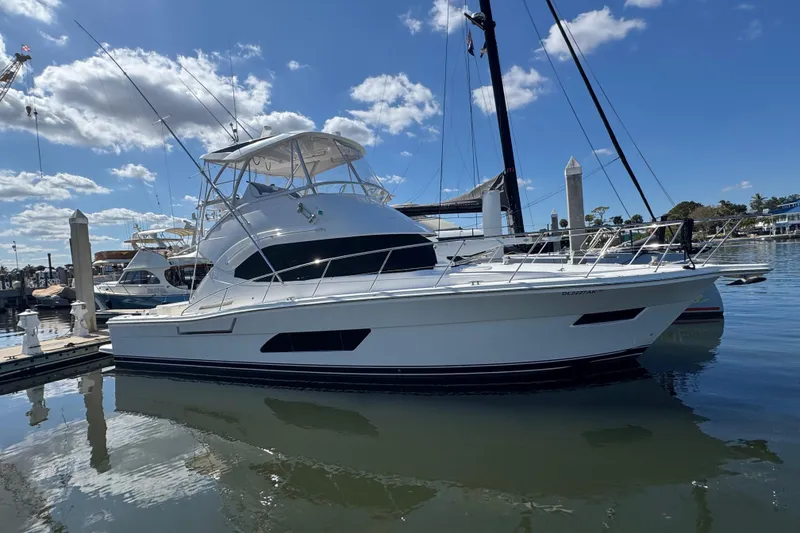 Slide: The Image of 2016 Riviera 43 Open Flybridge yacht docked in a sunny marina. - 3