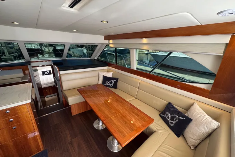 Slide: The Image of Luxurious interior of 2016 Riviera 43 Open Flybridge yacht with elegant seating and wooden table. - 8
