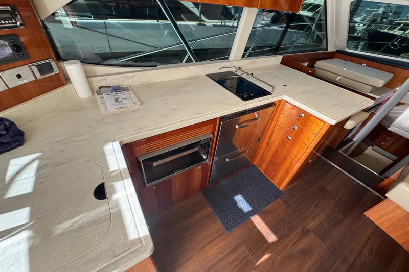 Slide: The Image of Luxurious 2016 Riviera 43 Open Flybridge yacht interior with modern kitchen and wood finish. - 9