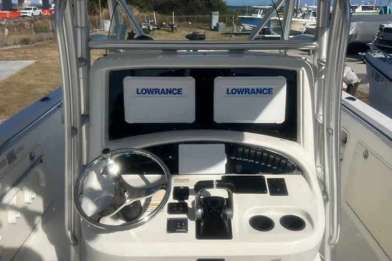 Slide: The Image of 2005 Boston Whaler 320 Outrage helm with dual Lowrance displays and steering wheel. - 10