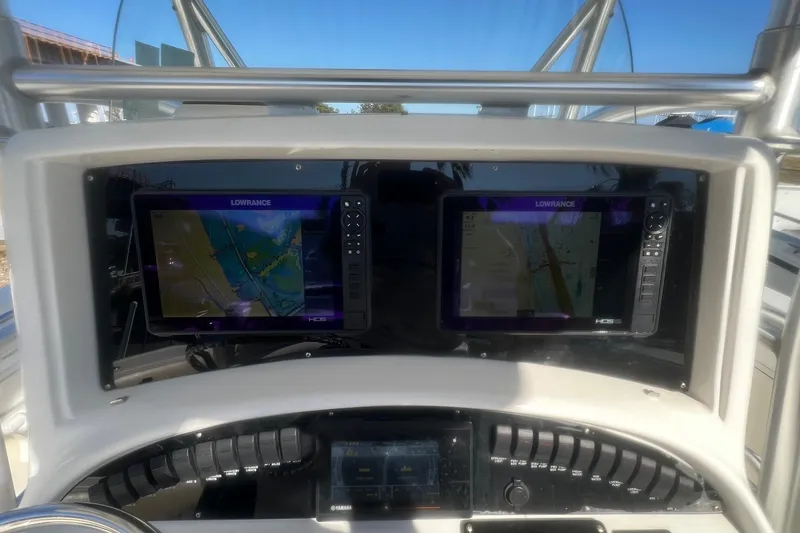 Slide: The Image of Dashboard of a 2005 Boston Whaler 320 Outrage with dual Lowrance navigation screens. - 13