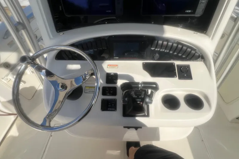 Slide: The Image of 2005 Boston Whaler 320 Outrage helm with steering wheel and control panel. - 15