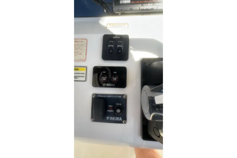 Slide: The Image of Control panel of a 2005 Boston Whaler 320 Outrage boat with Yamaha controls. - 16