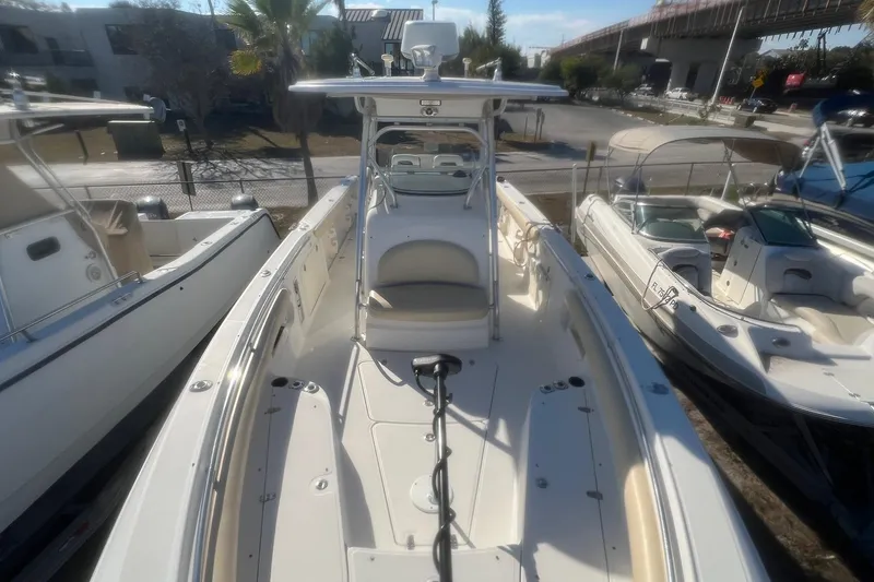 Slide: The Image of 2005 Boston Whaler 320 Outrage boat docked, showcasing spacious deck and seating area. - 17