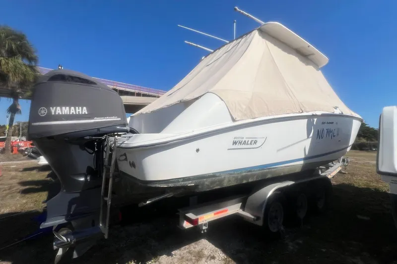 Slide: The Image of 2005 Boston Whaler 320 Outrage boat on trailer with Yamaha outboard motor. - 2