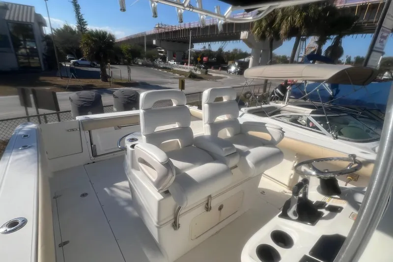 Slide: The Image of 2005 Boston Whaler 320 Outrage boat interior with helm and seating area. - 22