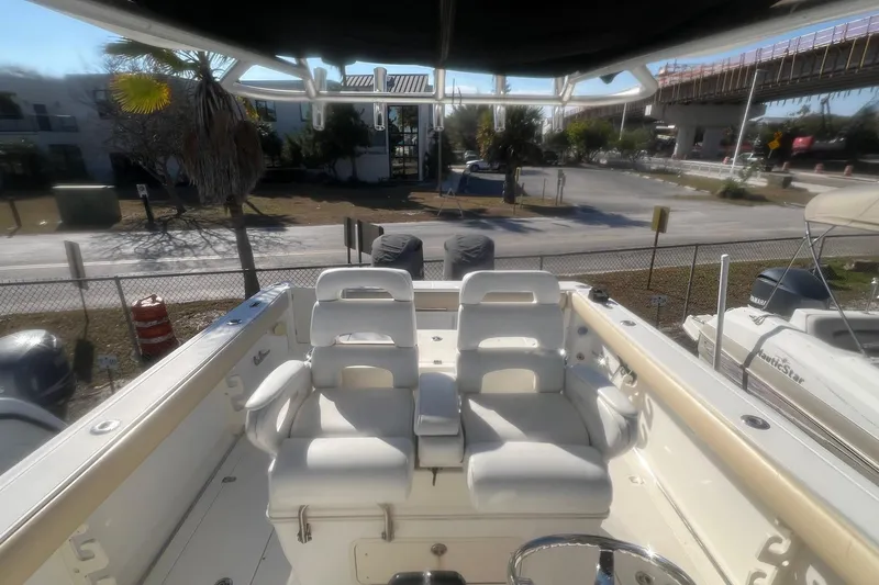 Slide: The Image of 2005 Boston Whaler 320 Outrage boat interior with dual seating and steering wheel. - 23