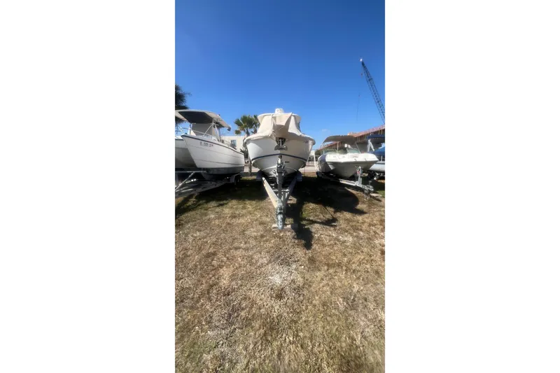 Slide: The Image of 2005 Boston Whaler 320 Outrage boat on trailer under clear blue sky. - 5
