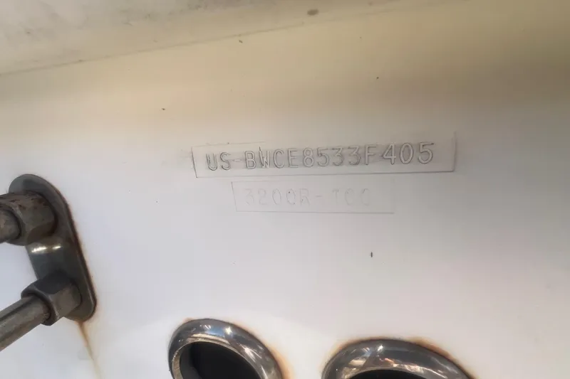 Slide: The Image of 2005 Boston Whaler 320 Outrage hull identification number on white surface. - 7