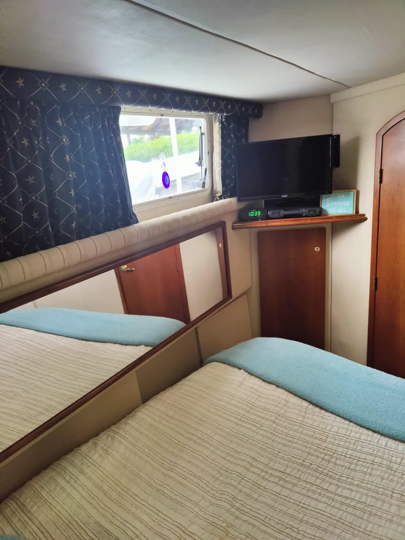 Slide: The Image of 2001 Cruisers Yachts 3750 Motoryacht bedroom interior with TV. - 11