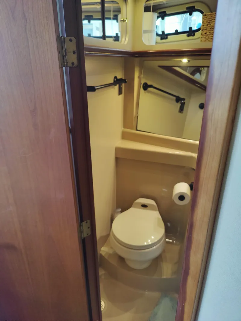 Slide: The Image of 2001 Cruisers Yachts 3750 Motoryacht bedroom with cozy bedding and elegant interior design. - 13