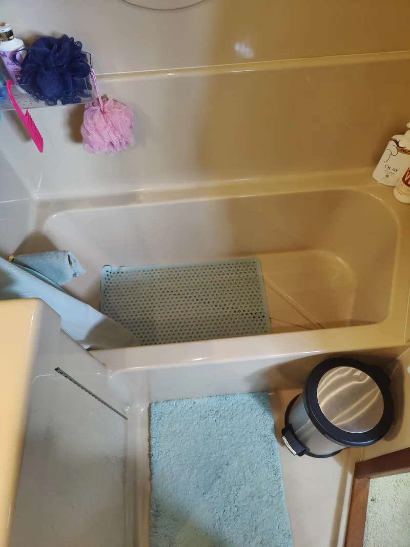 Slide: The Image of Luxurious 2001 Cruisers Yachts 3750 Motoryacht bedroom with cozy bedding and elegant wood cabinetry. - 15