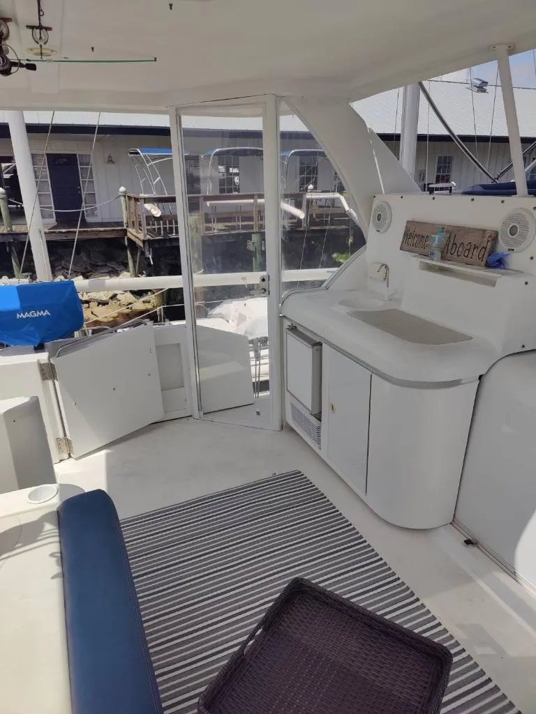 Slide: The Image of Inflatable dinghy with Suzuki outboard motor on 2001 Cruisers Yachts 3750 Motoryacht. - 27