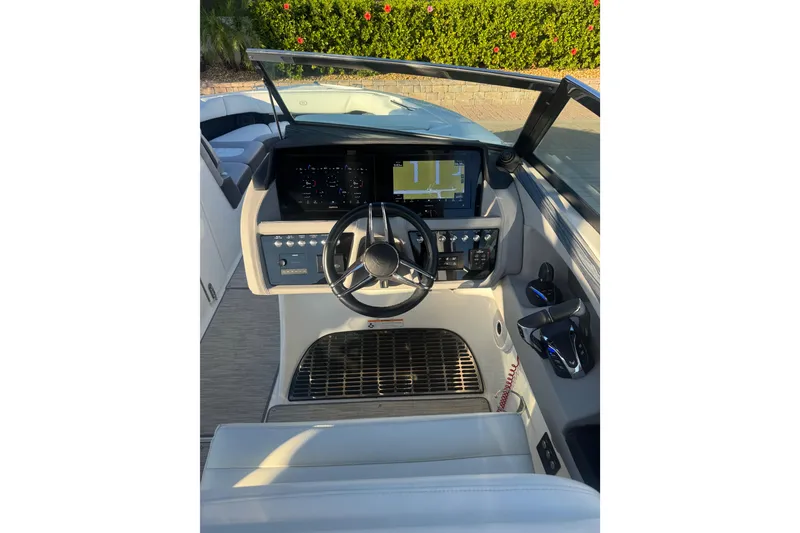 Slide: The Image of 2023 Cobalt 30SC Outboard helm with modern controls and navigation display. - 4
