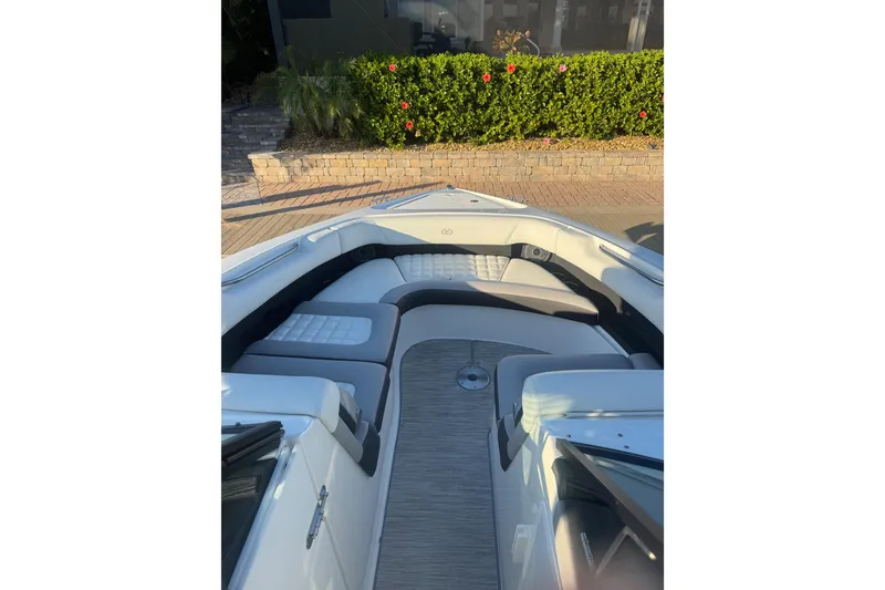 Slide: The Image of 2023 Cobalt 30SC Outboard boat interior with cushioned seating and sleek design. - 7