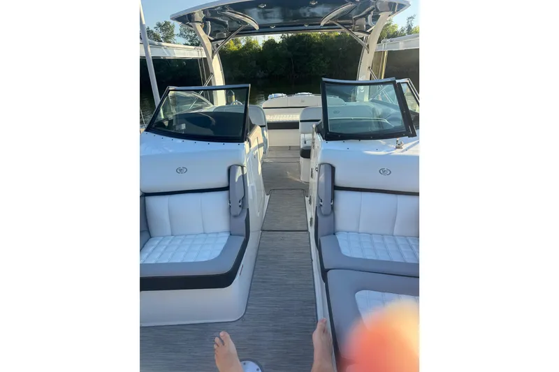 Slide: The Image of 2023 Cobalt 30SC Outboard boat interior with white seating and open deck view. - 8