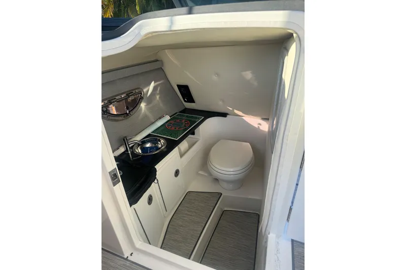 Slide: The Image of 2023 Cobalt 30SC Outboard boat interior with compact bathroom and sink. - 9