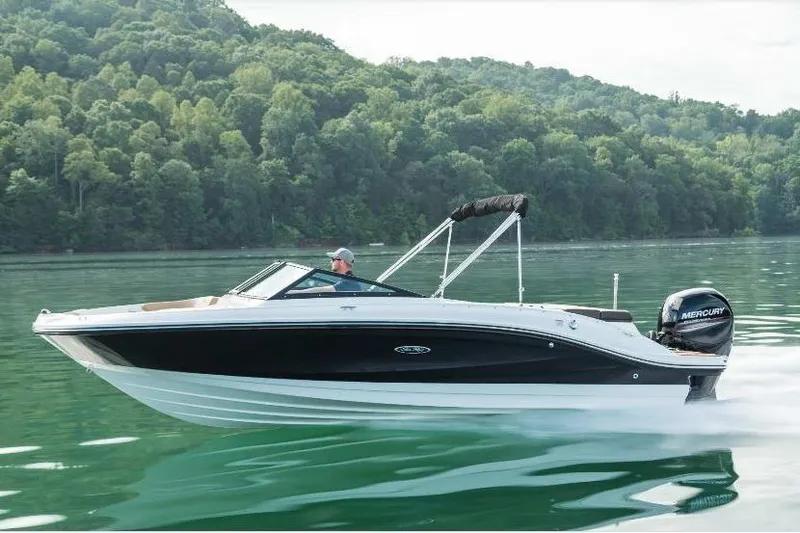 The Image of 2022 Sea Ray SPX 210 Outboard cruising on a serene lake with lush green hills. - 0