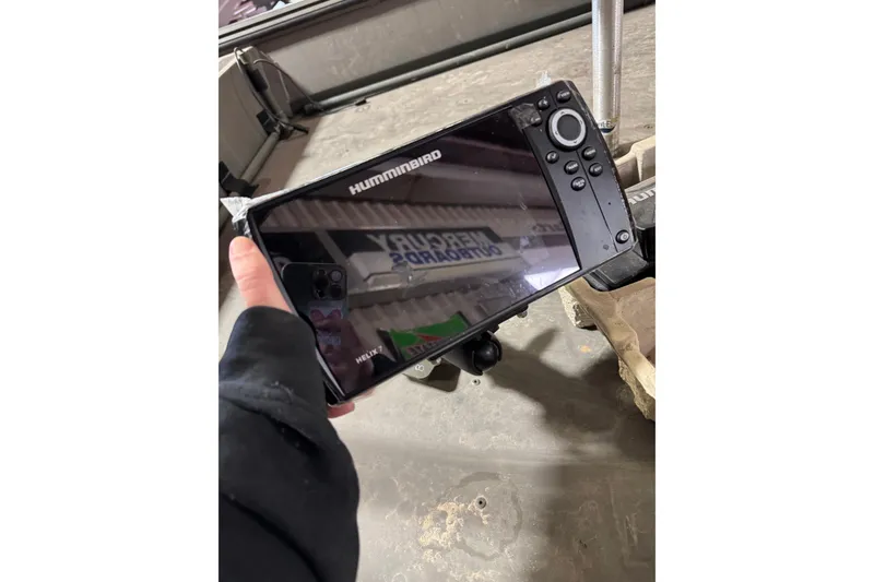 Slide: The Image of Hand holding Humminbird Helix 7 fish finder on War Eagle 648LDV boat, 2019 model. - 11