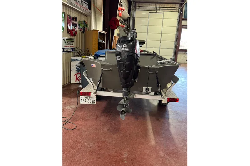 Slide: The Image of 2019 War Eagle 648LDV boat on trailer with outboard motor in garage. - 3