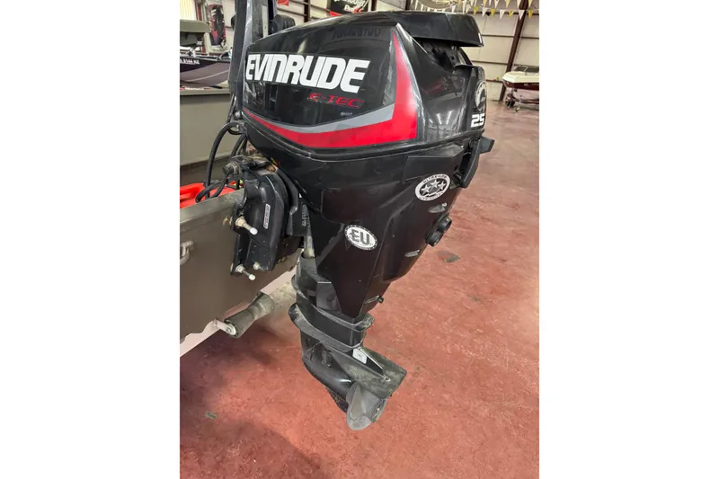 Slide: The Image of 2019 War Eagle 648LDV with Evinrude outboard motor in a garage setting. - 4