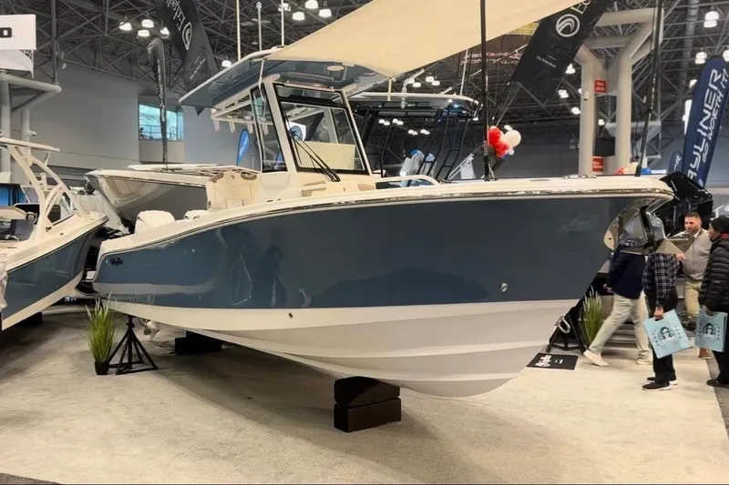 The Image of 2026 Edgewater 250CC boat displayed at a show. - 0