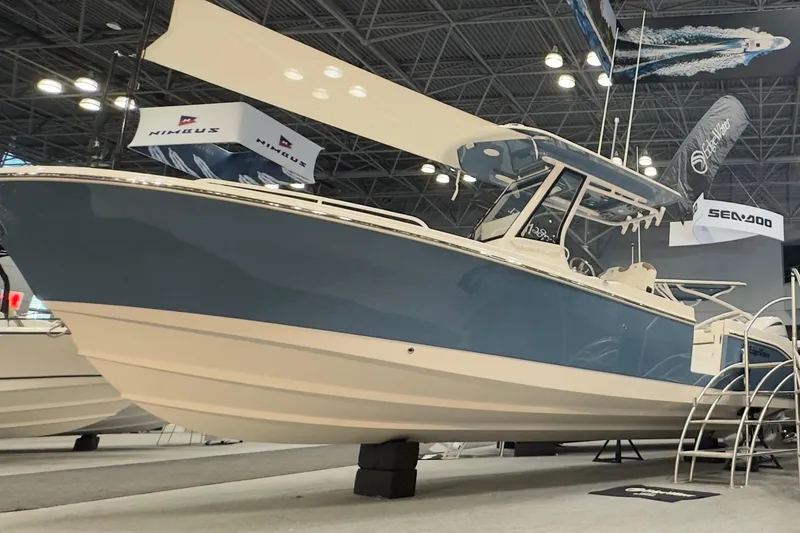 Slide: The Image of Edgewater 250CC boat 2026 displayed at a boat show. - 2