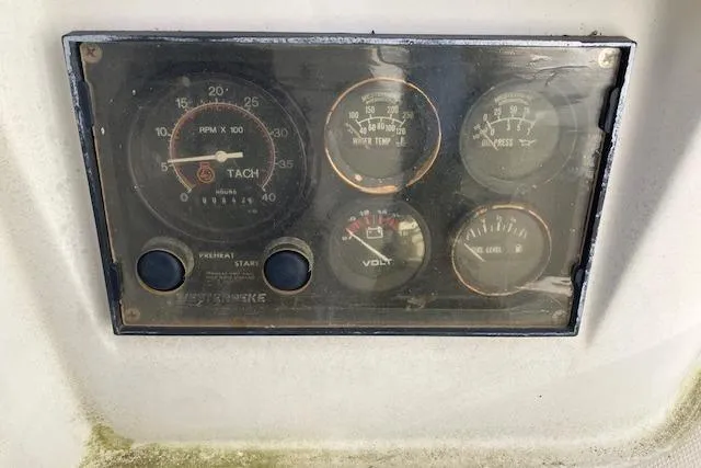 Slide: The Image of Instrument panel of a 1989 Sabre 30 boat, featuring tachometer and various gauges. - 12