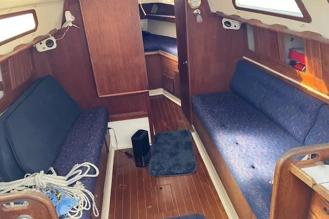 Slide: The Image of Interior of 1989 Sabre 30 sailboat with wooden finish and blue seating. - 15
