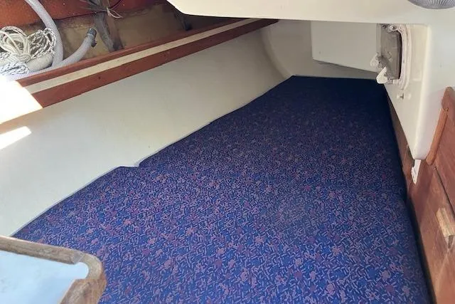 Slide: The Image of Interior cabin of 1989 Sabre 30 sailboat with blue patterned flooring. - 26