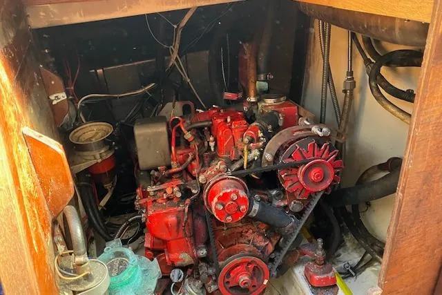 Slide: The Image of 1989 Sabre 30 engine compartment with red engine components and surrounding wiring. - 33