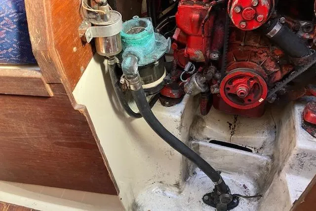 Slide: The Image of Engine compartment of a 1989 Sabre 30 sailboat, showing mechanical components and hoses. - 34