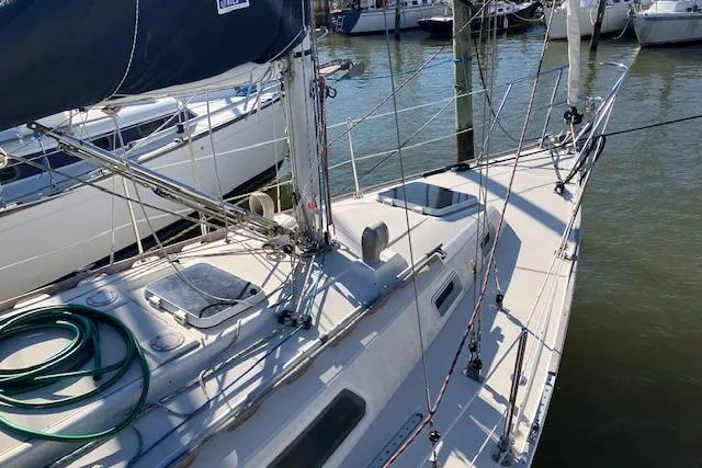 Slide: The Image of 1989 Sabre 30 sailboat docked, featuring deck details and rigging in a marina setting. - 4