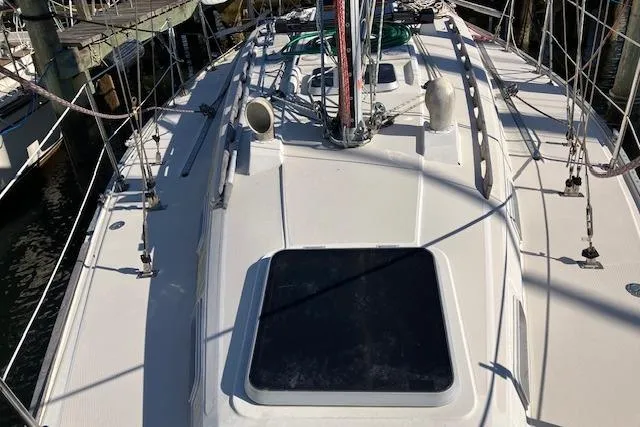 Slide: The Image of 1989 Sabre 30 sailboat deck view with rigging and hatch, docked at marina. - 5
