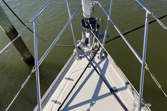 Slide: The Image of Bow of 1989 Sabre 30 sailboat with stainless steel railings and anchor setup. - 6