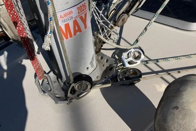 Slide: The Image of Sailboat rigging on 1989 Sabre 30, featuring ropes and pulleys, Alabama registration visible. - 7