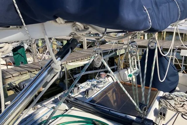 Slide: The Image of 1989 Sabre 30 sailboat deck with rigging and ropes at a marina. - 8