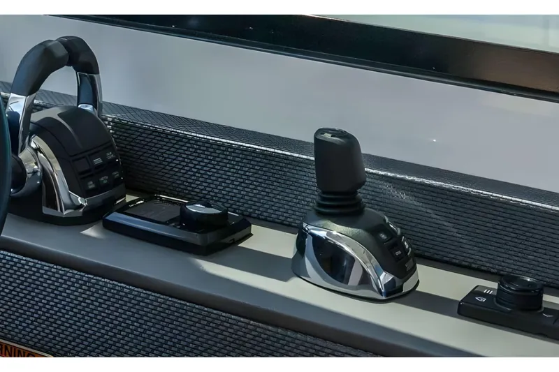 Slide: The Image of Control panel of 2018 Cruisers Yachts 50 Cantius, featuring joystick and throttle controls. - 15