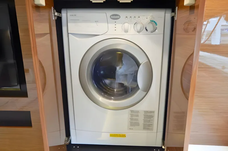 Slide: The Image of Washing machine inside 2018 Cruisers Yachts 50 Cantius, wooden cabinetry. - 20