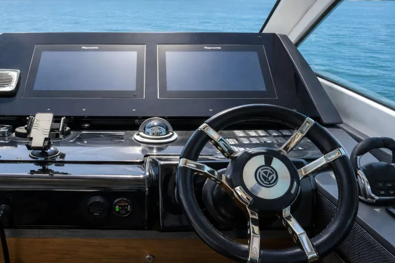 Slide: The Image of Helm of 2018 Cruisers Yachts 50 Cantius with dual screens and steering wheel. - 14