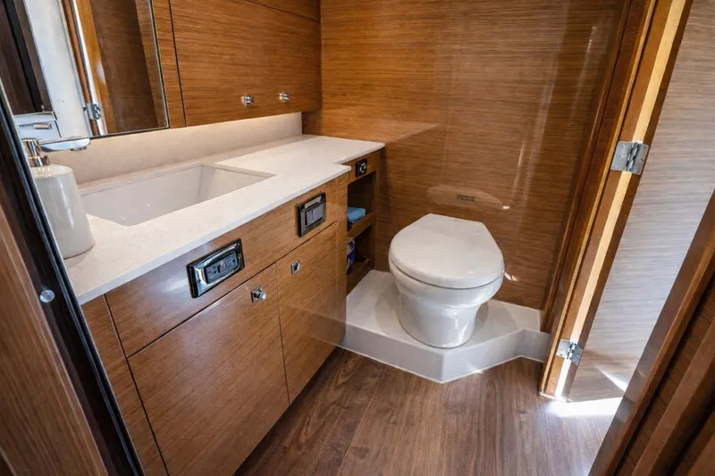 Slide: The Image of Luxurious bathroom in 2018 Cruisers Yachts 50 Cantius with modern fixtures and wood finish. - 21