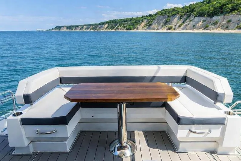 Slide: The Image of 2018 Cruisers Yachts 50 Cantius deck with seating and ocean view. - 8