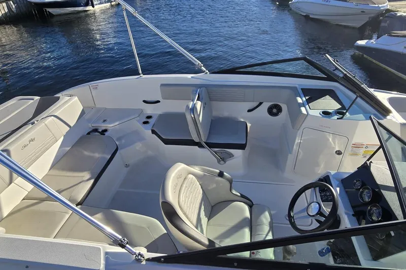 Slide: The Image of 2023 Sea Ray SPX 210 Outboard boat interior with seating and steering wheel. - 15
